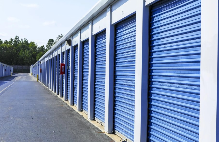 Custom made Industrial Sheds, row of storage sheds with blue roller doors.