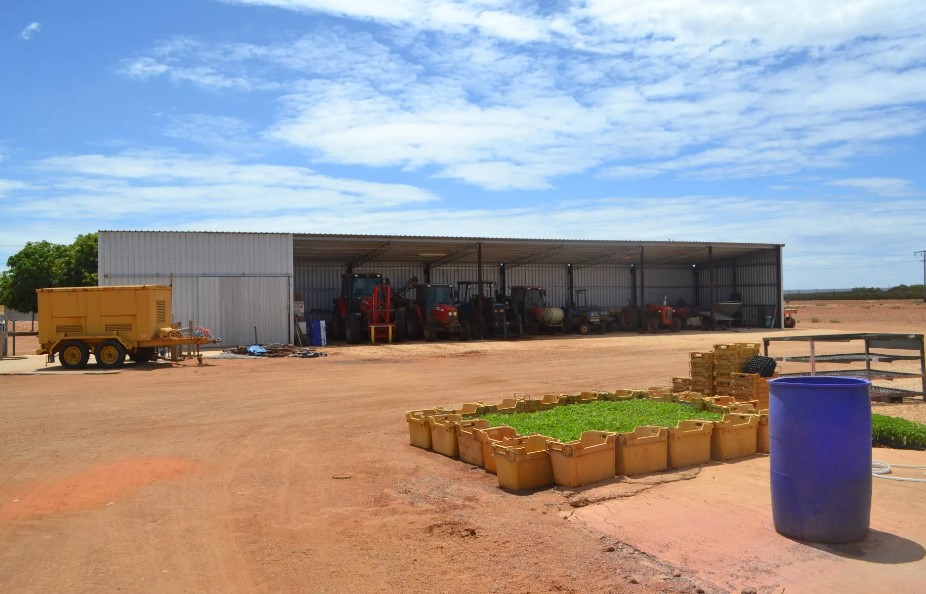 Custom made open front farm shed showing stored farm machinery.