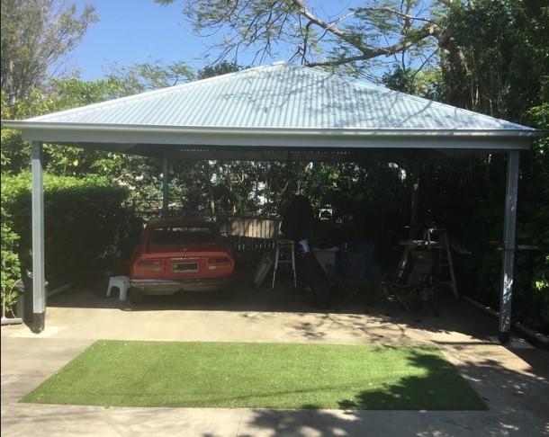 A Carport Kit protects against Hailstorms.- photo of a hip roof carport